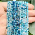 Close-up of blue faceted dragon vein agate beads for DIY jewelry in various sizes. - Lake Blue