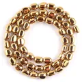 Macro detail van gepolijste gouden ovale hematiet kralen voor DIY sieraden maken materiaal - 5-8 mm / Gepolijst Goud