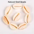 Detailed view of natural cream-colored cowrie shell beads for DIY jewelry making - 10-20mm Random (1 Piece) / Natural Shell