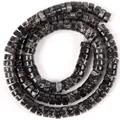 Detailed close-up view of 6x3mm natural stone spacer beads with black marbled stone texture - Black Imperial Stone