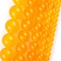 Detail shot of various sized yellow natural stone round beads for jewelry making - 6mm (Approx 58 Pieces/Pack) / Topaz Chalcedony (B Color)