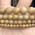 Close-up macro detail of yellow striped natural stone round beads for jewelry making - 6mm (Approx 58 Pieces/Pack) / Serpenggiante