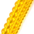 Close-up detail of translucent yellow natural stone round beads for jewelry - 6mm (Approx 58 Pieces/Pack) / Yellow Glass Beads