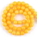 Close-up detail of polished yellow natural stone round beads for DIY jewelry making crafts - 6mm (Approx 58 Pieces/Pack) / Yellow Cream Jade