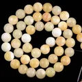 Macro view of polished yellow natural stone round beads for DIY jewelry making crafts - 6mm (Approx 58 Pieces/Pack) / Light Yellow Topaz