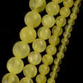 Close-up of natural yellow stone round beads in various sizes for jewelry making - 6mm (Approx 58 Pieces/Pack) / Yellow Qingyu Jade