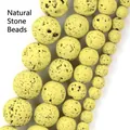 Macro view of yellow natural lava stone round beads with porous texture for jewelry making - 6mm (Approx. 58 Pieces) / Yellow-Green Hematite Volcanic Stone