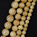 Detailed macro shot of yellow natural stone round beads showing unique internal textures - 6mm (Approx 58 Pieces/Pack) / Semi-Transparent Citrine