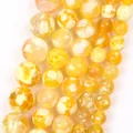 Close-up detail of yellow natural stone round beads with unique dragon vein patterns - 6mm (Approx. 58 Pieces) / Yellow Round Fire Agate