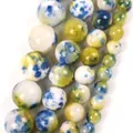 Close-up detail of variegated blue and yellow natural stone round beads for DIY jewelry - 6mm (Approx. 58 Pieces) / Yellow Blue Persian Jade