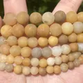 Macro detail view showing texture of natural yellow stone round beads for jewelry making - 6mm (Approx. 58 Pieces) / Frosted Yellow Jade