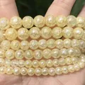 Detailed macro shot of translucent yellow cracked quartz round beads for DIY jewelry making - 6mm (Approx. 58 Pieces) / AB Color Light Yellow Crackle