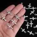 Detailed close-up view of silver cross pendants for DIY jewelry and bracelet making - Cross / 100pcs Pack