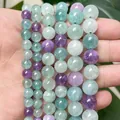 Detailed close-up of translucent green and purple fluorite round beads on multiple strands - 58 Pieces (6mm) / A+ Green Multicolor Fluorite Chalcedony