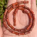 Macro detail showing the natural texture of 5x12mm red stone bamboo section spacer beads - One Strand Approx 31 Pieces (5x12mm) / Red Jasper