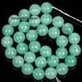 Close-up of translucent green fluorite stone beads for DIY jewelry making and craft projects - Green Angelite Stone / 12mm (Approx. 30 Pieces)