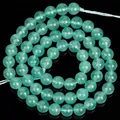 Macro detail view of natural translucent green angelite round beads for DIY jewelry making - Green Angelite Stone / 6mm (Approx 56 Pieces)