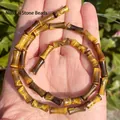 Macro view of 5x12mm bamboo-shaped natural tiger eye stone beads for DIY jewelry making - One Strand Approx 31 Pieces (5x12mm) / Yellow Tiger Eye