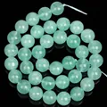 Macro detail of natural light green angelstone round beads for DIY jewelry making - Green Angelite Stone / 10mm (Approx. 36pcs)