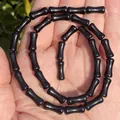 Macro view of highly polished 5x12mm black onyx bamboo-joint shaped beads for DIY jewelry making - One Strand Approx 31 Pieces (5x12mm) / Black Agate