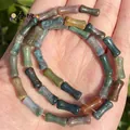 Detailed macro view of 5x12mm bamboo-shaped natural chalcedony and agate mixed stone beads. - One Strand Approx 31 Pieces (5x12mm) / India Agate