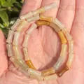Close-up of natural bamboo-joint chalcedony beads with a smooth texture for DIY - One Strand Approx 31 Pieces (5x12mm) / Old Yellow Jade