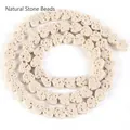 Close-up detail of porous heart-shaped natural beige volcanic stone beads for DIY jewelry - 6x7mm (Approx 60-62 Beads) / Beige
