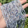 Macro detail of faceted iridescent light blue crystal glass beads for DIY jewelry - Approx 112 Pieces Pack / 4x3mm