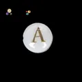 Close-up of a white round mother-of-pearl bead with an engraved gold letter A - Letter A (s2256) / 10 Pieces 8x5mm