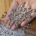 Close-up of shiny silver-toned large hole spacer beads for DIY bracelet jewelry making - 5.8mm / Silver