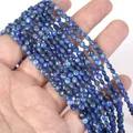 Detailed view of 4mm faceted blue stone disc beads held in hand for DIY jewelry making - 1 Strand Approx 98 Beads (4mm) / Lapis Lazuli