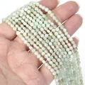 Close-up of 4mm faceted mint green natural stone disc beads for DIY jewelry making - 1 Strand Approx 98 Beads (4mm) / Prehnite 2