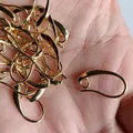 Gold-plated DIY ear hook findings for handmade jewelry crafting shown in a palm shot - 1# Vintage Ear Hook / 1 Piece / 18K Gold