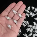 Macro view showing the metallic texture of skull crossbones charms for DIY jewelry. - Skull / 100pcs Pack
