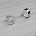 Close-up detail showing the structure of clear silicone earring backs with silver decorative ring - Wide Rim / 6.5*5mm / White Gold