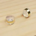 Close-up detail of clear silicone earring backs featuring gold-plated metal bands - Wide Rim / 6.5*5mm / Gold