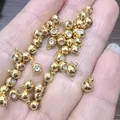 Detailed view of 18K gold plated silicone positioning spacer beads with loop for DIY jewelry - 4mm / 1 Piece / 18K Gold Plated Brass