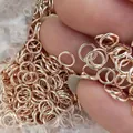 Close-up of rose gold open jump rings for DIY jewelry making and handmade crafts - 0.7*5mm / Rose Gold