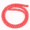 Close-up showing the unique porous texture of red 4x4mm square lava stone beads - 85 Pieces/Pack / Red