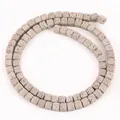 Detailed close-up view of 4x4mm square grey lava stone beads for DIY jewelry making - 85 Pieces/Pack / Gray