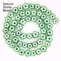 Macro shot of 8mm green flower-shaped millefiori glass beads for jewelry making - Approx 52 Pieces per Strand / Green
