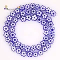 Detailed view of 8mm blue and white plum blossom Millefiori glass beads for DIY jewelry crafting - Approx 52 Pieces per Strand / Sapphire Blue