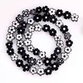 Macro view of 8mm black and white flat plum blossom lampwork beads for jewelry DIY - Approx 52 Pieces per Strand / Black