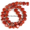 Macro detail view of 10mm heart-shaped red jasper stone beads for jewelry craft DIY projects - Heart Imported Red Stone / 10mm / Red Jasper