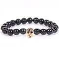 Trendy 8mm polished black stone bead bracelet featuring a micro-pave gold skull charm - 19cm 8mm / Obsidian Gold Skull