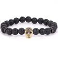 Fashionable 8mm black lava stone bracelet featuring a golden micro-pave skull charm - 19cm 8mm / Volcanic Stone Gold Skull