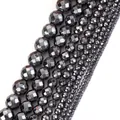 Close-up of faceted dark gray hematite beads in various sizes for jewelry making - Faceted Round Beads (HT0028) / 2mm (Approx 170 Pieces) / Gunmetal Grey