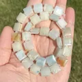 Detailed macro view of natural square Amazonite beads held in palm showing textures - Irregular Shape / Square Amazonite 10mm