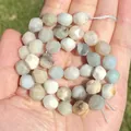 Close-up detail of faceted natural amazonite stone beads held in hand showing textures. - 6mm Approx 58pcs / Faceted Amazonite