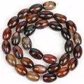Close-up of polished coffee brown dragon vein agate rice beads for DIY jewelry crafting - 8x12mm Oval Rice Beads / 31 Pieces/Strand / Dream Agate Rice Beads